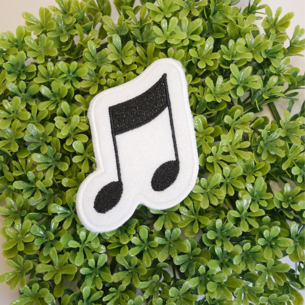 Music note patch on a green leafy background