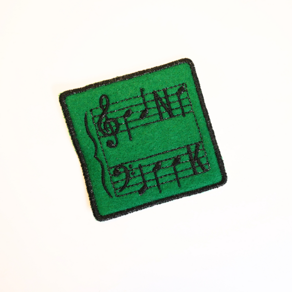 Green patch with musical notes on a white background