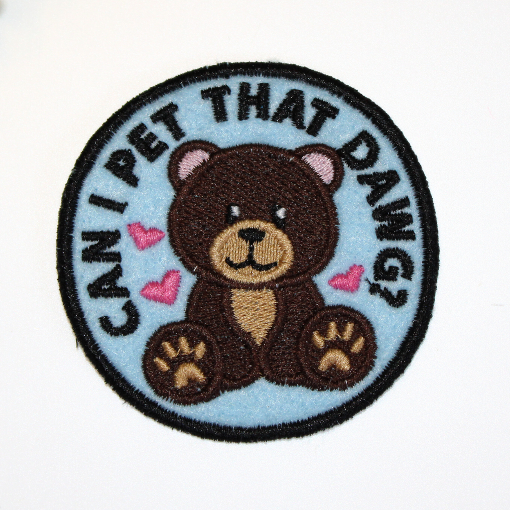 Embroidered patch with a bear design and text 'Can I pet that dawg?' on a light blue background.