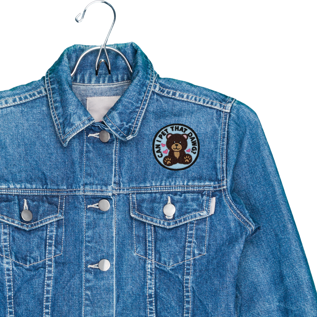 Blue denim jacket with a patch on a white background