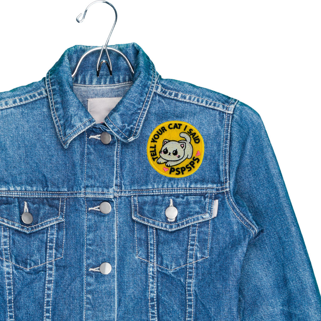 Blue denim jacket with a patch on a white background
