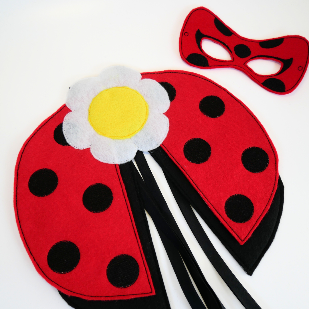 Red felt ladybug wings with black spots and a white flower