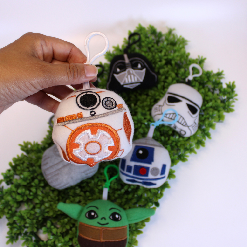 Set of Star Wars-themed keychains on a green background