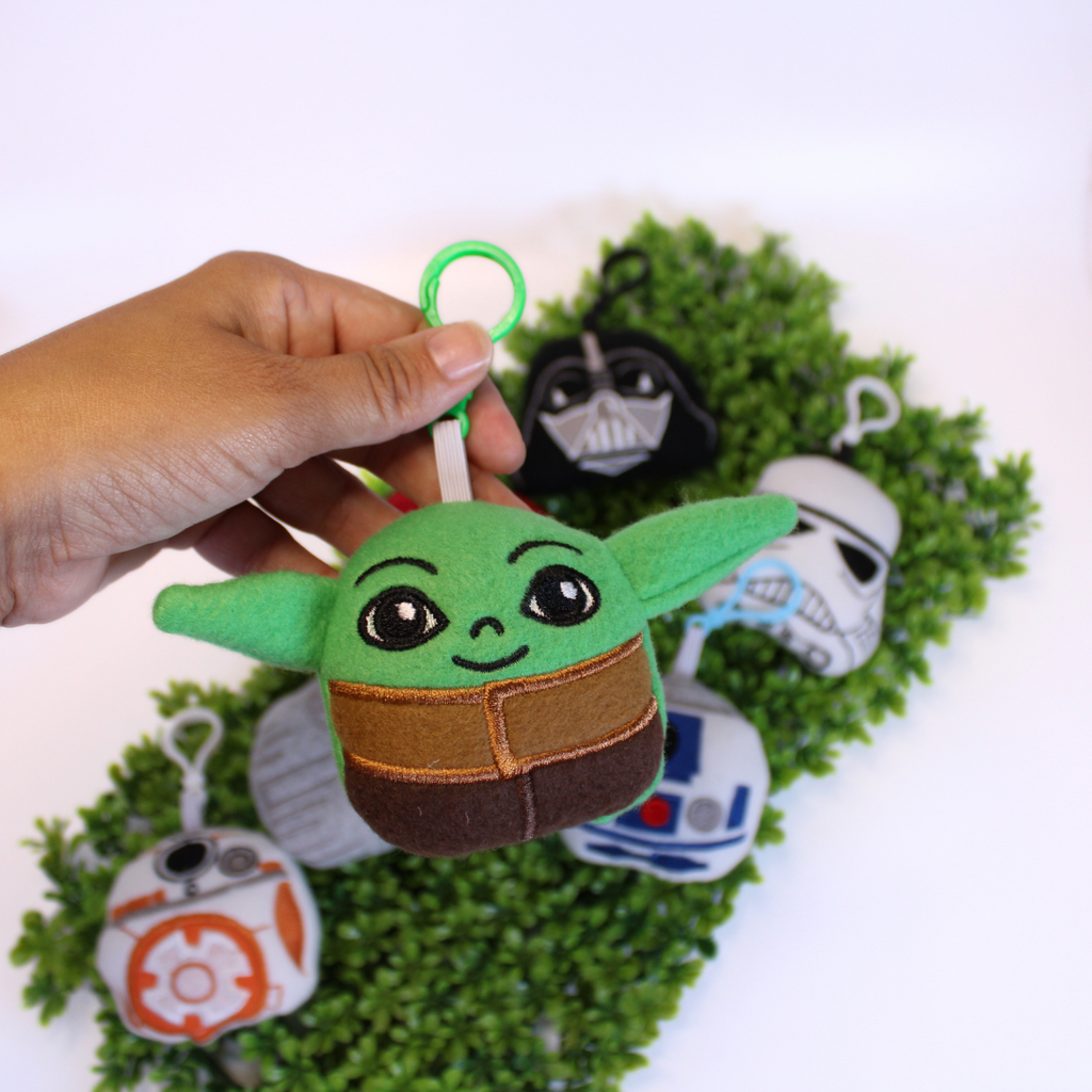 Set of Star Wars-themed keychains on a green background