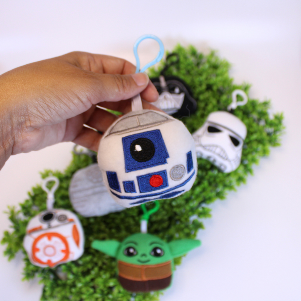Set of Star Wars-themed keychains on a green background