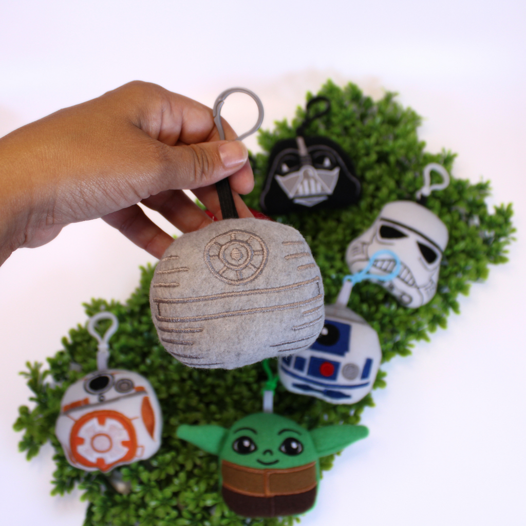 Set of Star Wars-themed keychains on a green background