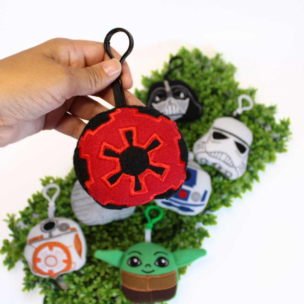 Set of Star Wars-themed keychains on a green background
