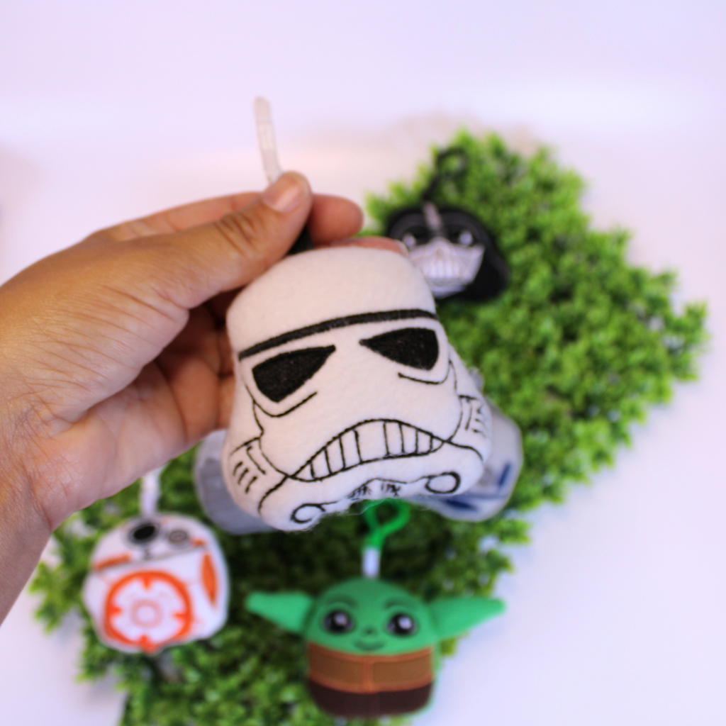 Set of Star Wars-themed keychains on a green background