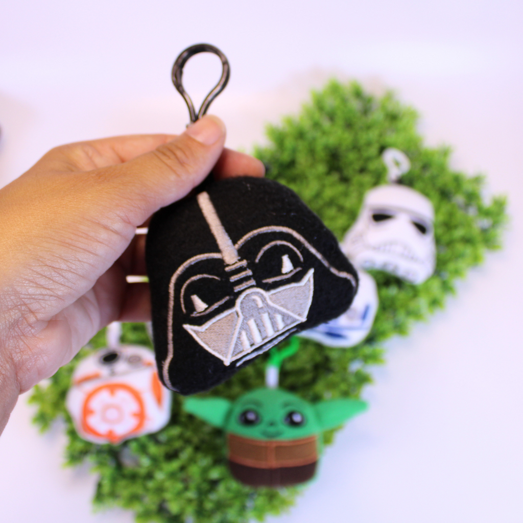 Set of Star Wars-themed keychains on a green background