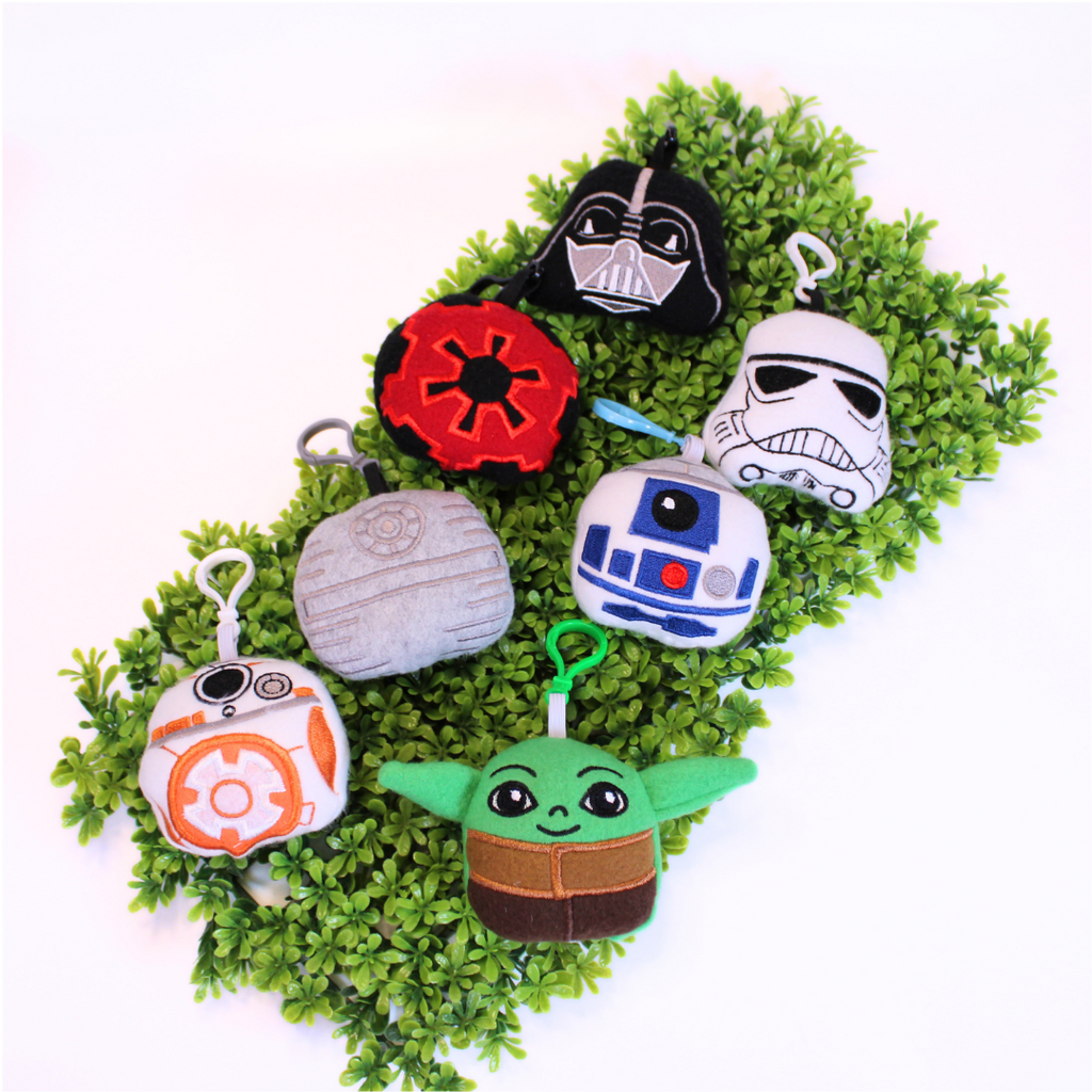 Set of Star Wars-themed keychains on a green background