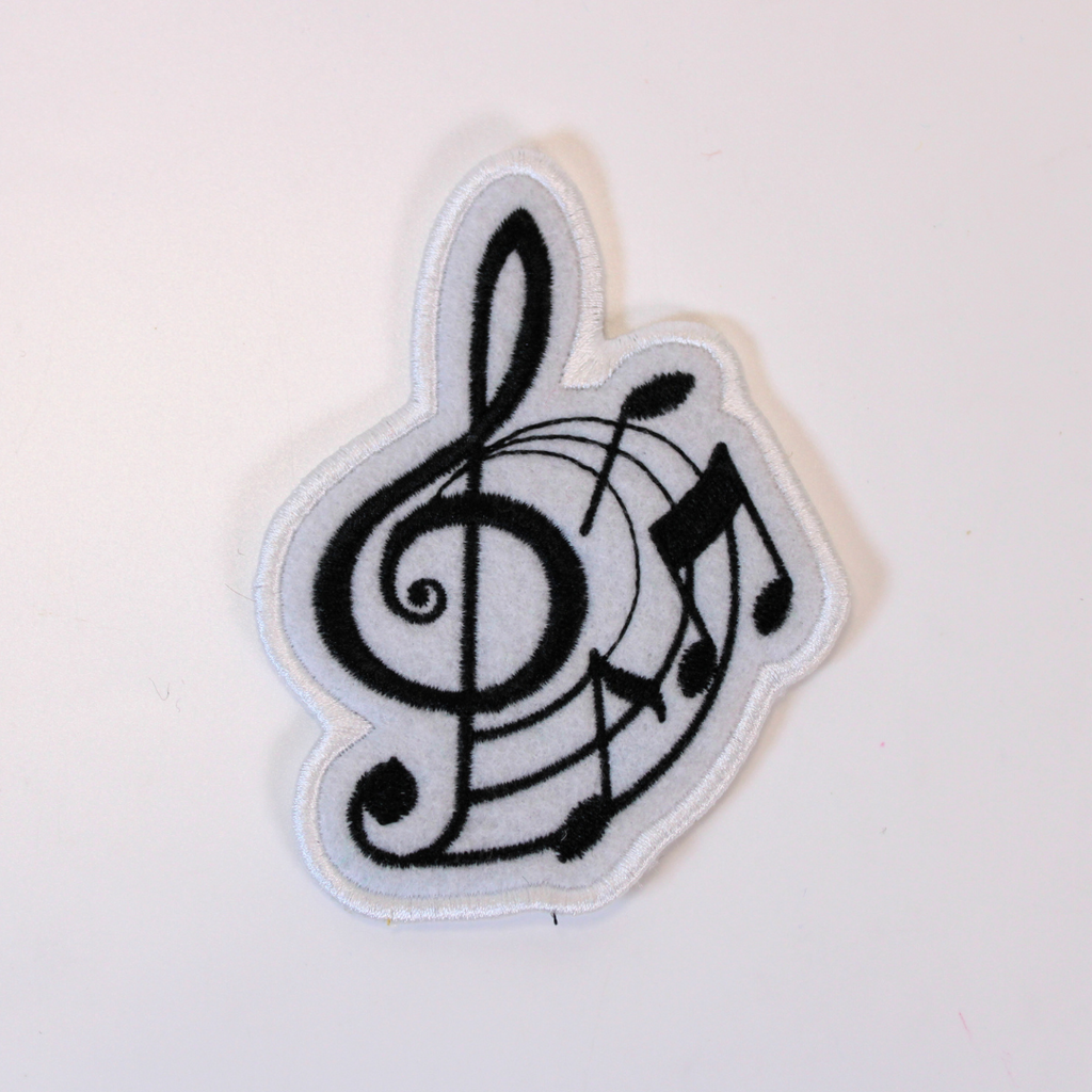 Music-themed patch with treble clef and notes on a white background