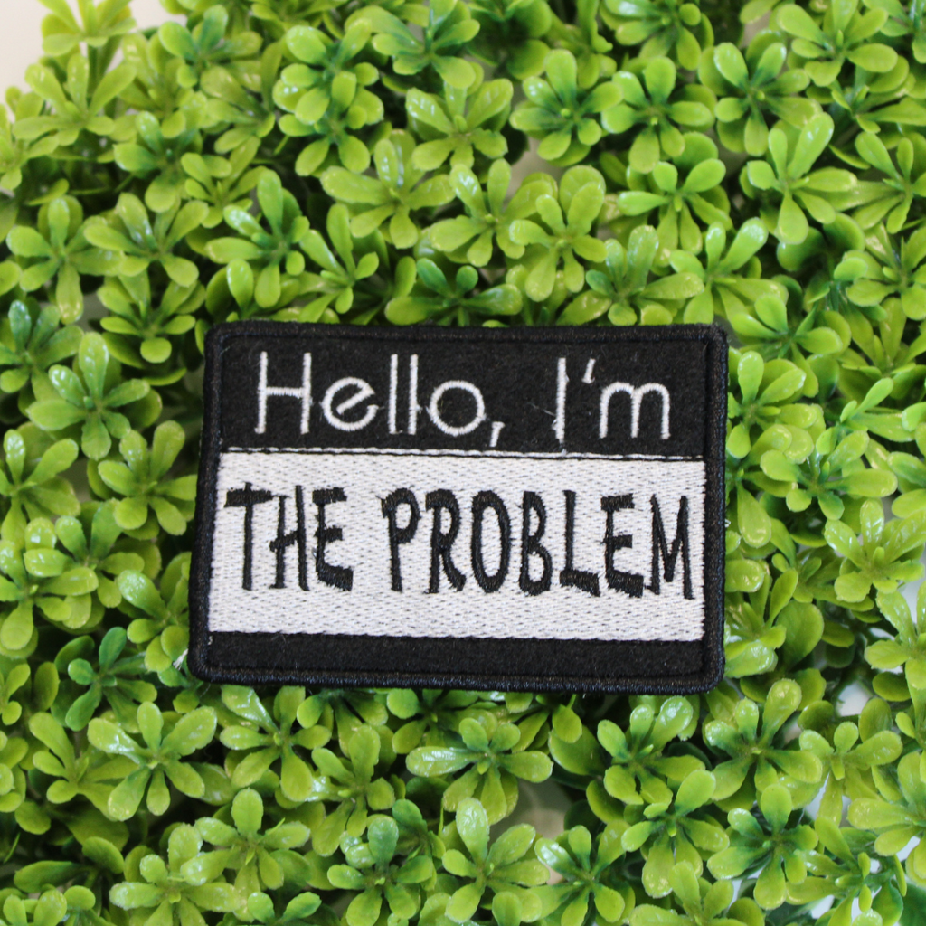 Patch with 'Hello, I'm THE PROBLEM' text on a green leafy background