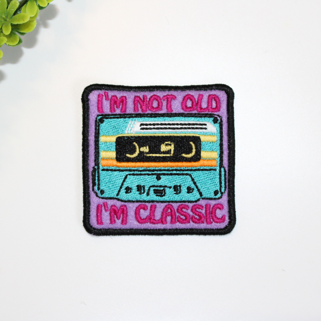Embroidered patch with a cassette tape design and text 'I'm not old, I'm classic' on a white background.