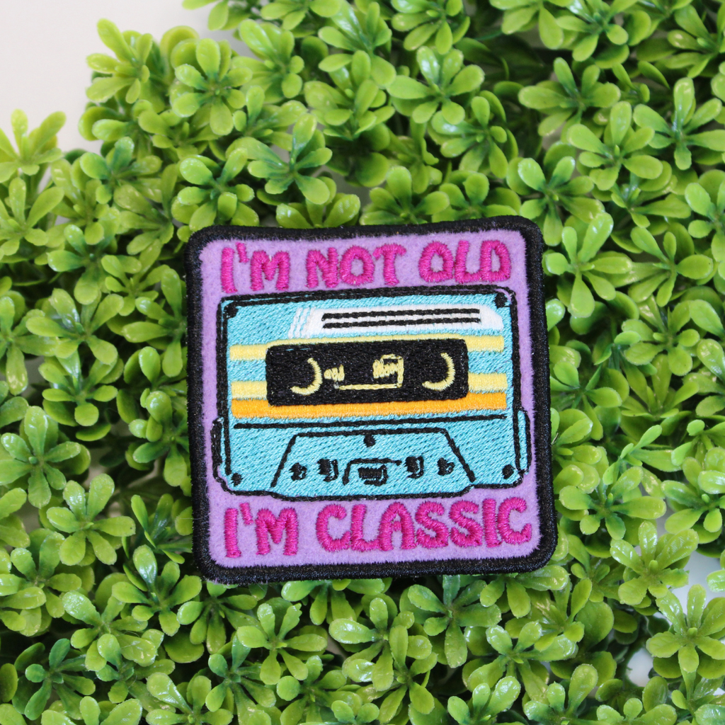 Patch with cassette tape design and text 'I'm not old, I'm classic' on a green leaf background