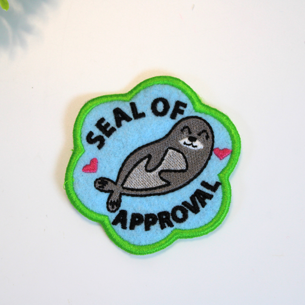 Patch with a seal illustration and 'Seal of Approval' text on a light blue background