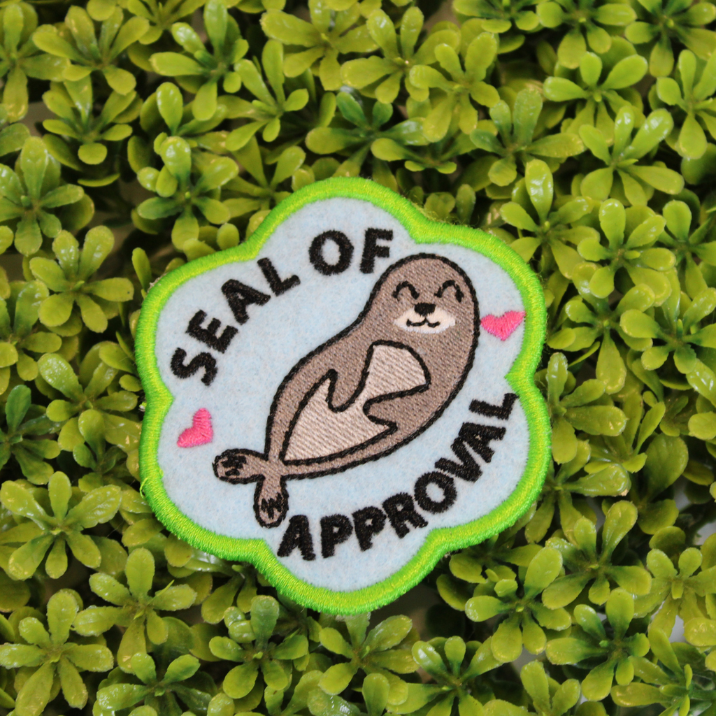 Patch with a seal design and 'Seal of Approval' text on a green leaf background