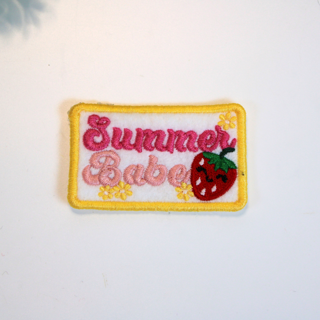 Embroidered patch with 'Summer Babe' text and strawberry design on a white background