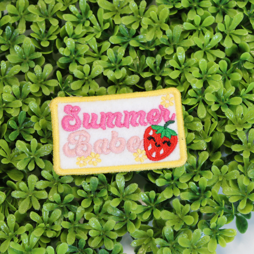 Embroidered patch with 'Summer Babe' text and strawberry graphic on green leaves